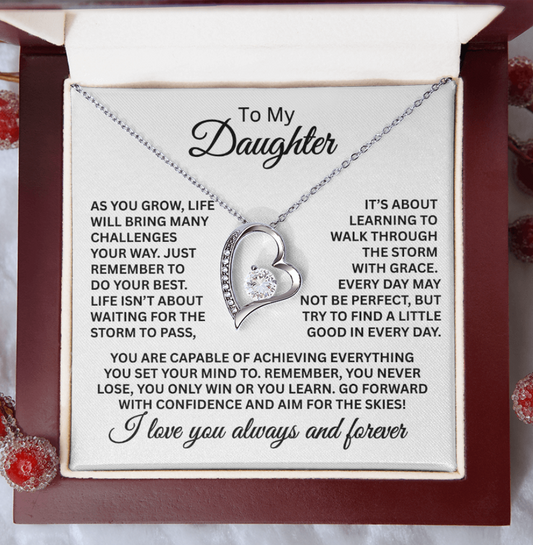 Necklace with heart pendant and engraved message for daughter on a decorative card.