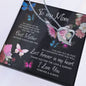 To my Mom, necklace and card. Card has butterflies and flowers on a black background.