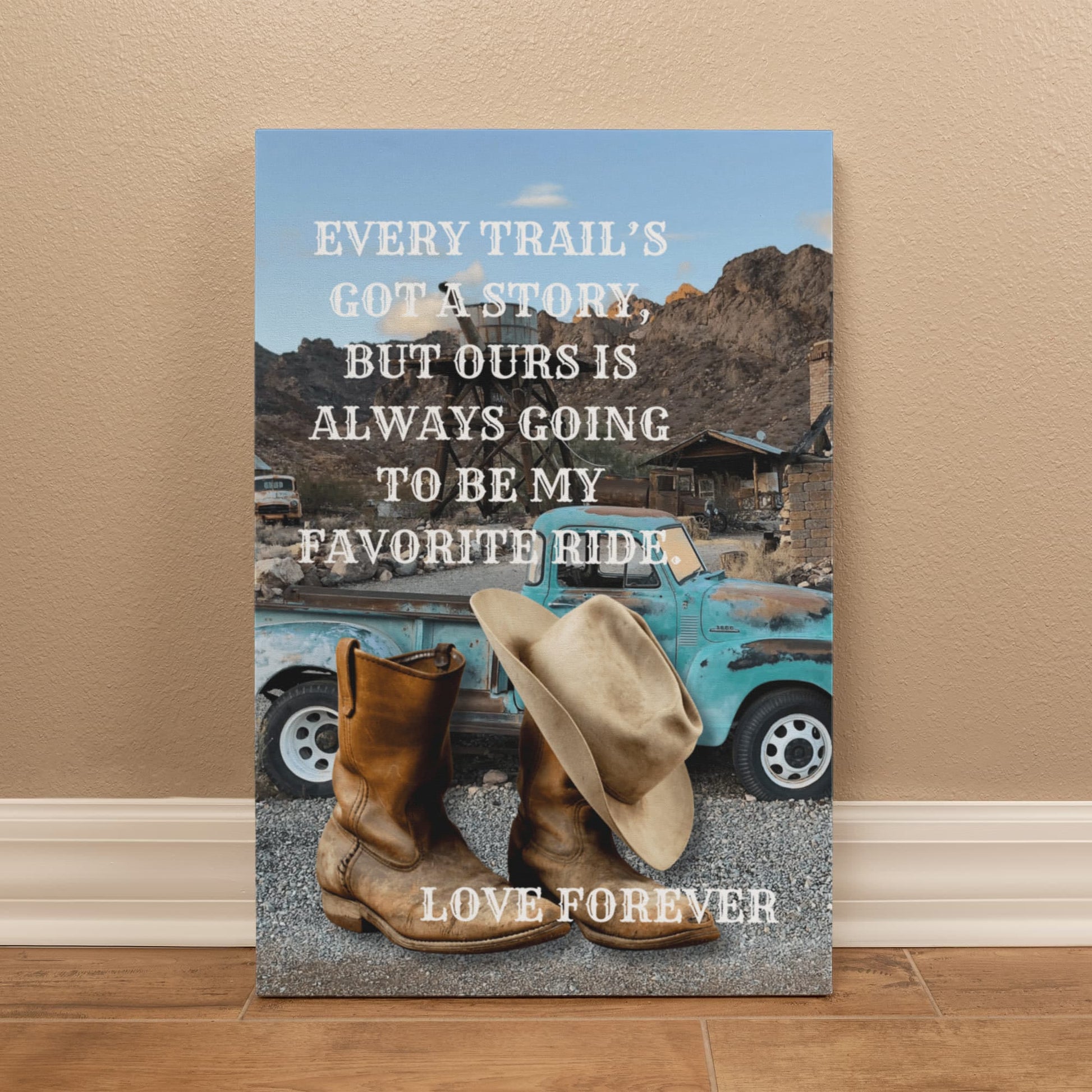 Canvas print with cowboy boots, hat, and vintage truck on a mountain background with text.